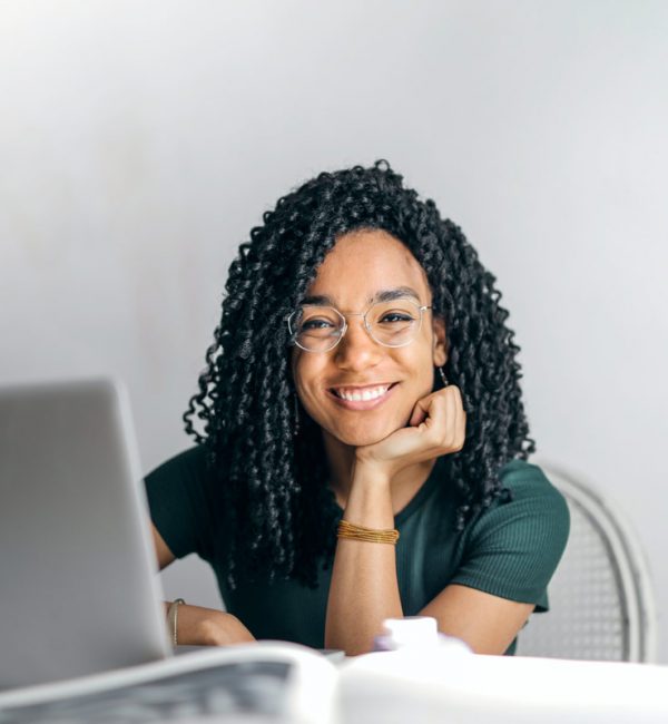 happy-ethnic-woman-sitting-at-table-with-laptop-3769021.jpg